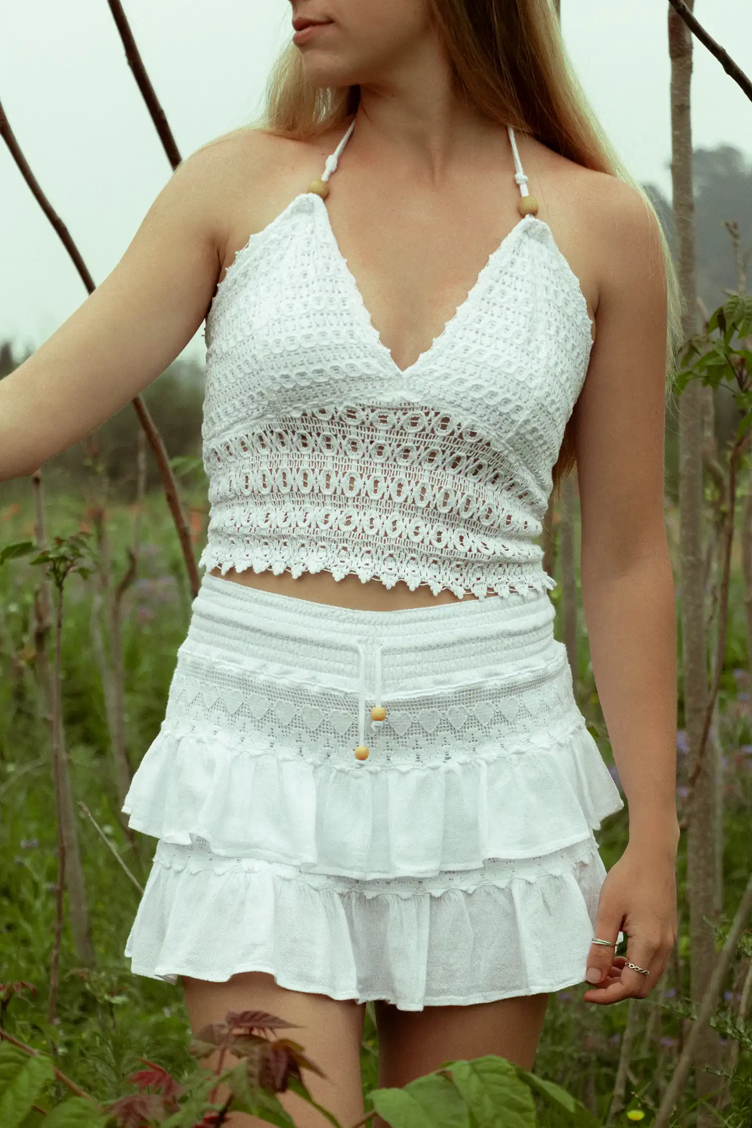 Modelo femenina con una falda ibicenca blanca en el campo