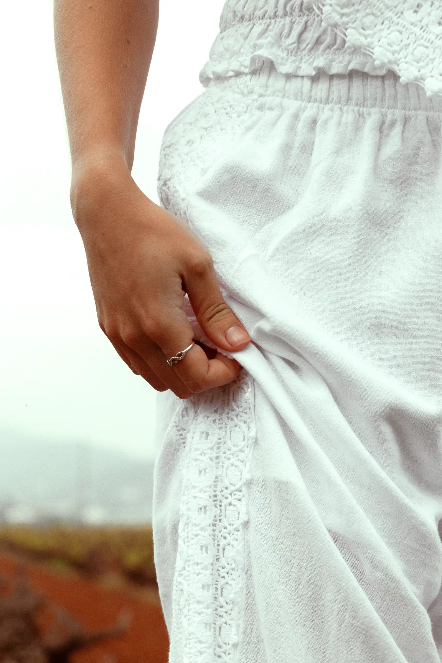 Pantalón ibicenco de mujer blanco en un campo de viñas, vista detalle
